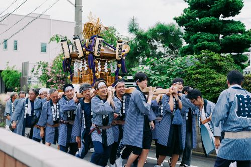 Free A lively festival procession with men carrying a mikoshi, showcasing cultural tradition. Stock Photo
