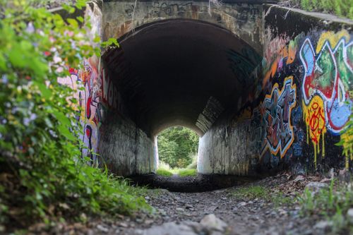 Free Colorful graffiti adorns the walls of a tunnel in Needham, MA, creating an urban art scene. Stock Photo