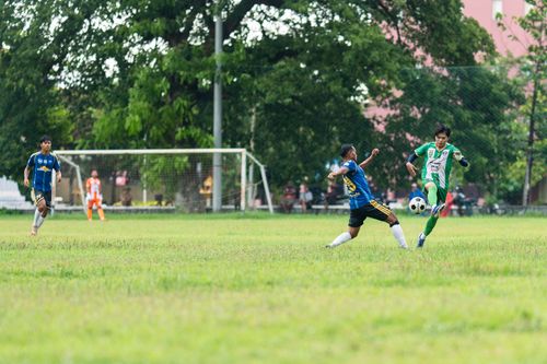 Free Dynamic amateur soccer match capturing players in action on a green field. Stock Photo