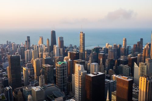 Free Stunning aerial view of the Chicago skyline with Lake Michigan in the background during sunset. Stock Photo