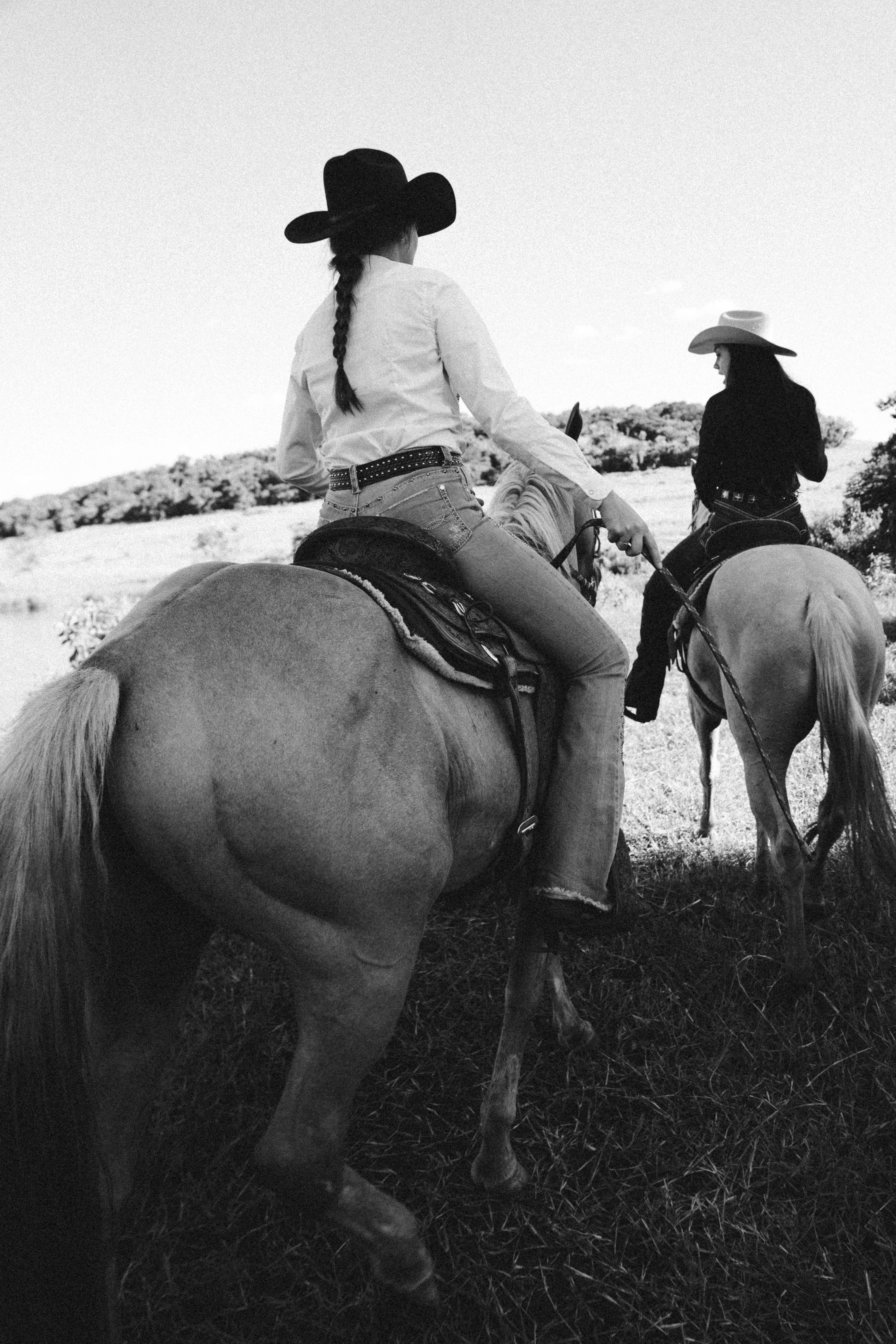 Two cowgirls on horseback explore the scenic fields of Brazil, showcasing rural adventure.