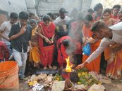 Ethnic people gathering near bonfire during religious ritual