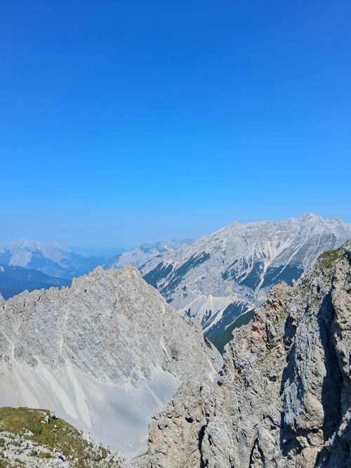 Free Breathtaking view of a rugged alpine mountain range under a clear blue sky. Stock Photo