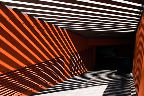 Free Abstract architectural scene capturing dynamic diagonal lines and shadow play in a Hamburg underpass. Stock Photo