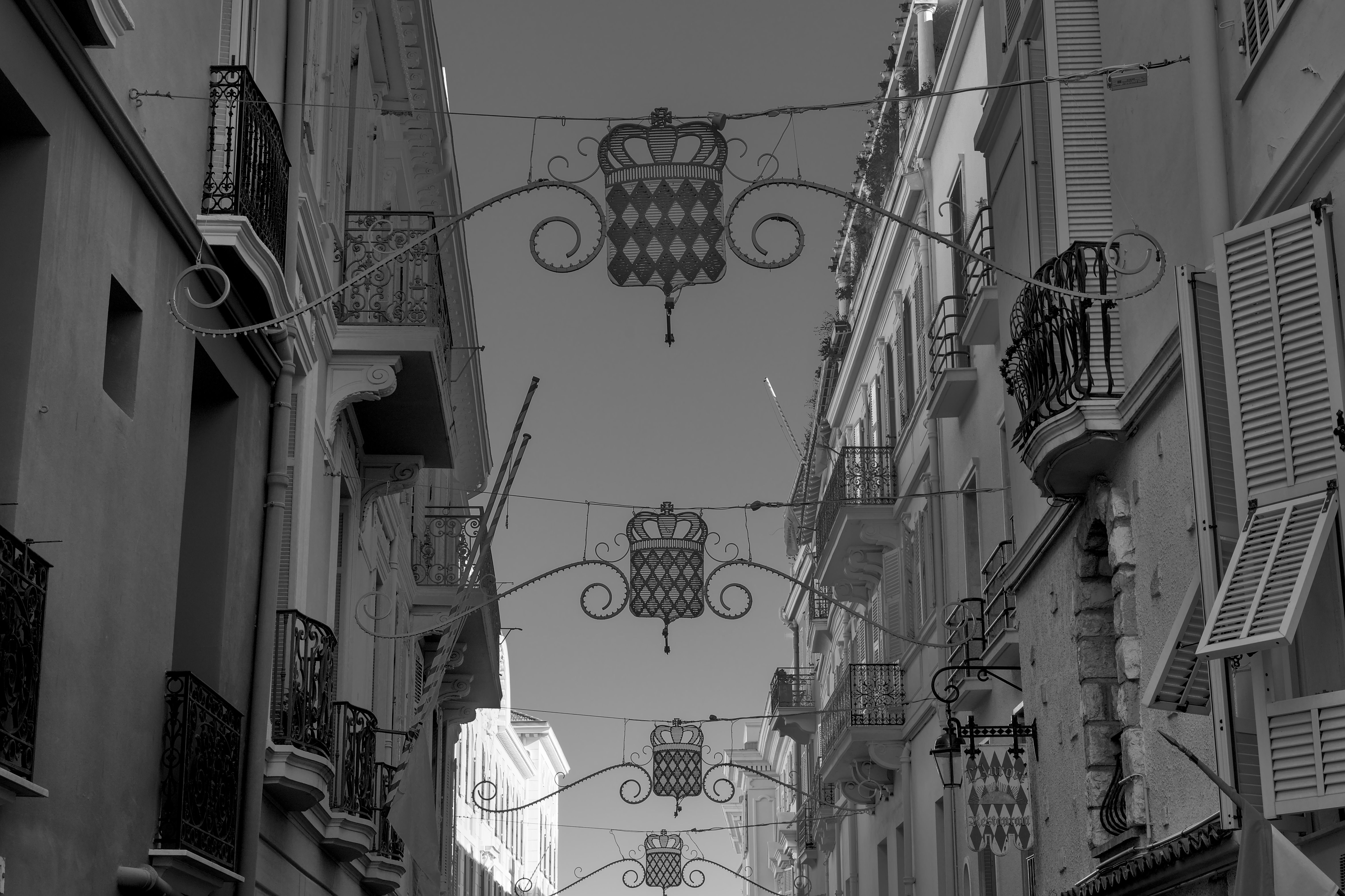Black and white view of a decorative street adorned with flags in Monaco.