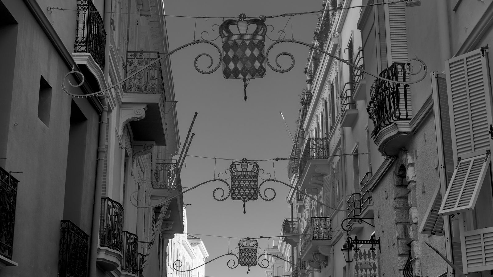 Black and white view of a decorative street adorned with flags in Monaco.