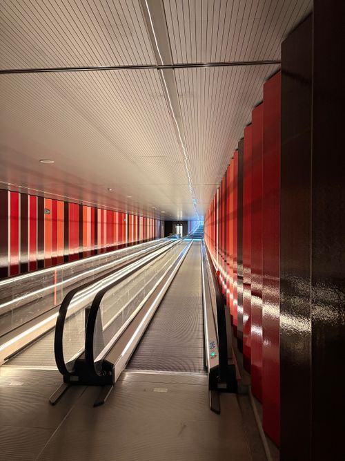 Free A modern indoor tunnel in Denmark with a moving walkway and bright lighting. Stock Photo