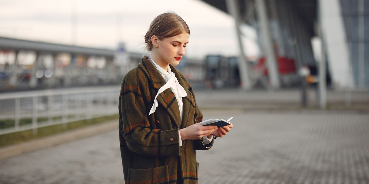 Traveler holding a passport at an airport, Europe ETIAS travel authorization