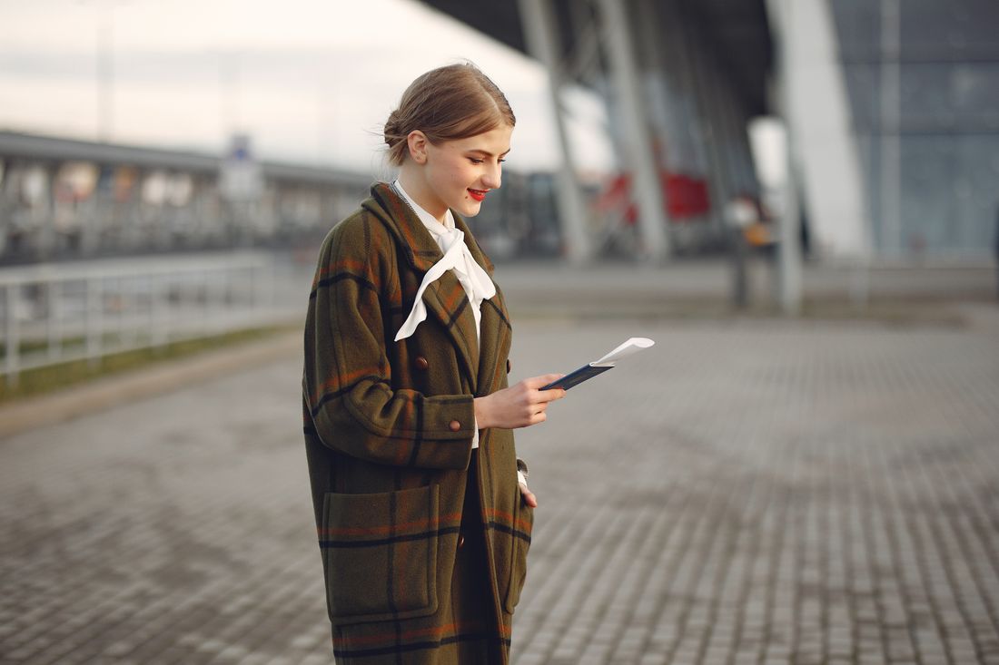 Traveller reviewing passport and visa documents before a journey