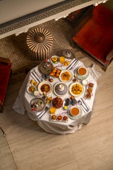 Sumptuous Moroccan feast with traditional dishes elegantly presented in an overhead view.