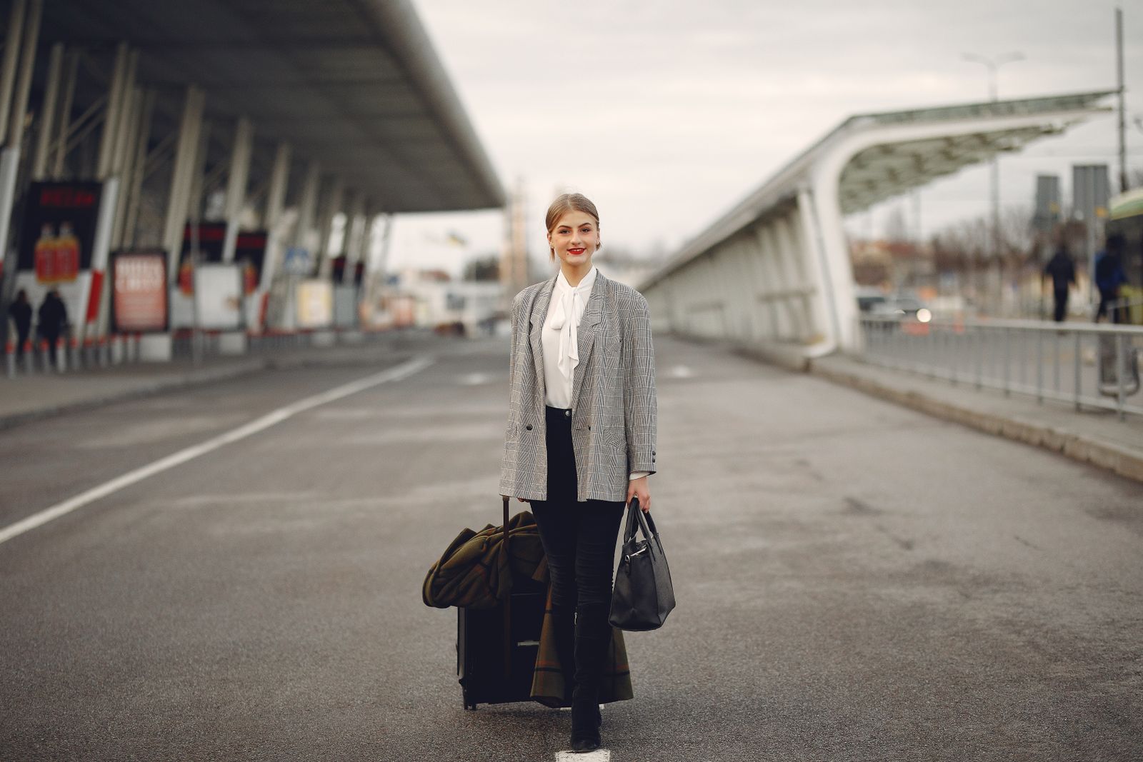 Traveler with luggage at an airport, matching compression stocking selection for travel. Photo: Pexels.