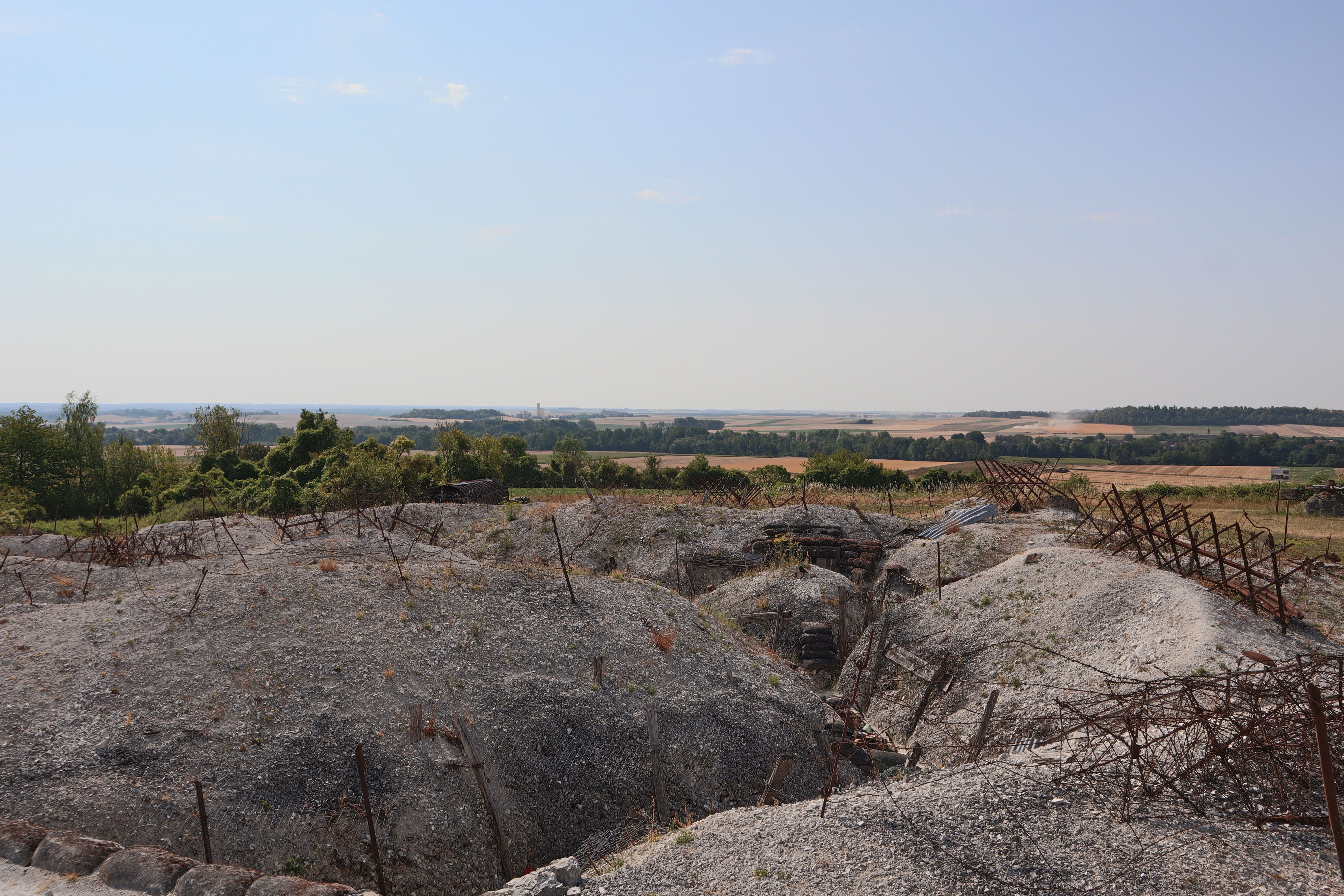Panoramic view of WWI battlefield trenches in Massiges, France, with summer landscape.