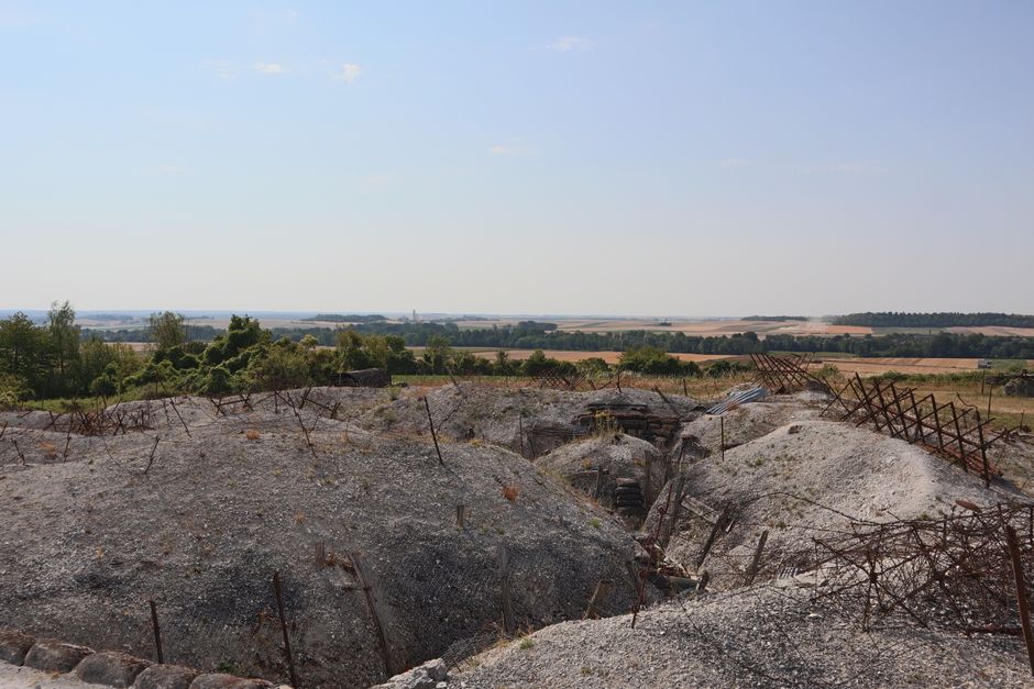 Panoramic view of WWI battlefield trenches in Massiges, France, with summer landscape.