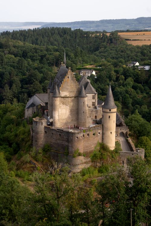 Free Aerial view of Vianden Castle surrounded by lush greenery in Luxembourg, capturing historical elegance. Stock Photo