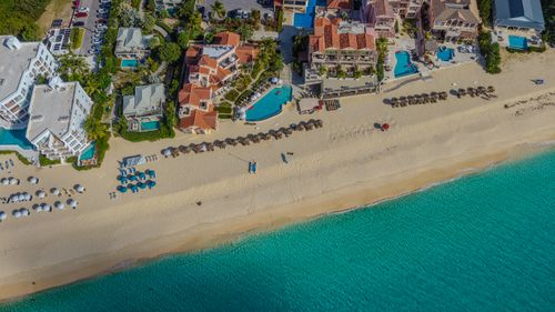 Free Aerial view of Anguilla's pristine beachfront with resort amenities and turquoise waters, ideal for travel inspiration. Stock Photo