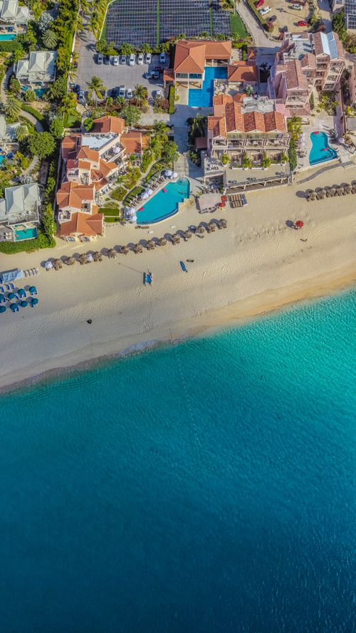 Free A breathtaking aerial view of a beachfront resort in Anguilla, showcasing vibrant turquoise waters and sandy beach. Stock Photo