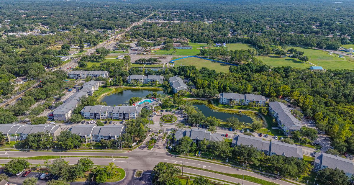 High-altitude photo showing a suburban area in Brandon, Florida with housing, greenery, and water features.