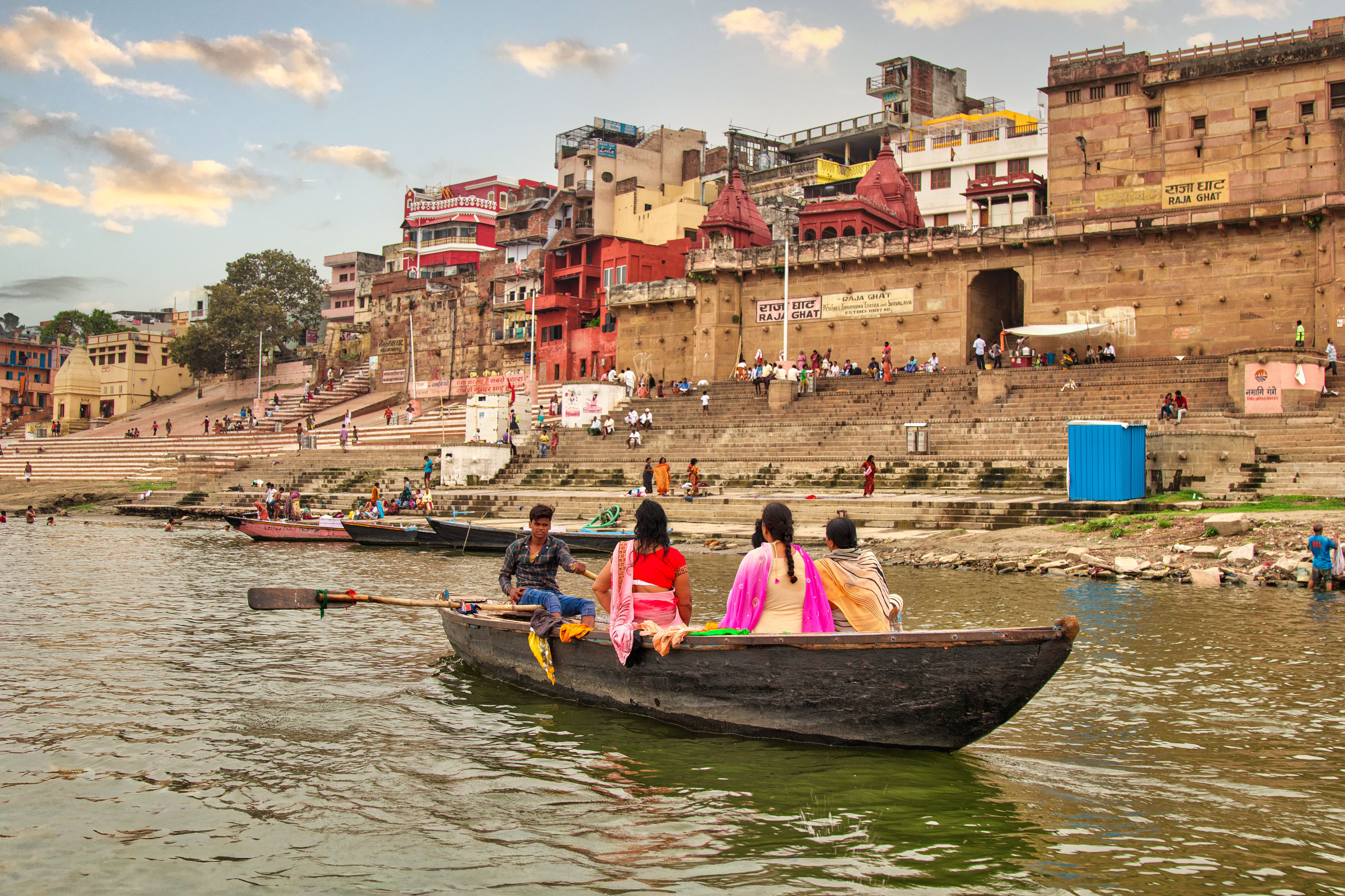 A serene boat ride along the Ganges River with a backdrop of Varanasi's historic ghats. — photo by Chandi Saha / Pexels
