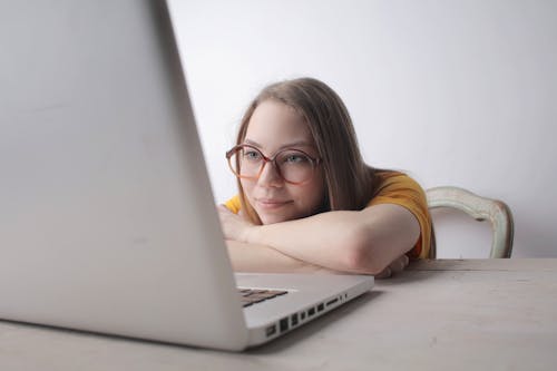 Woman Wearing Brown Framed Eyeglasses Using Laptop