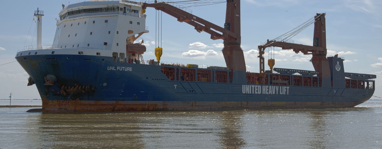 Cargo ship 'UHL Future' stationed at Emden harbor under a clear blue sky.