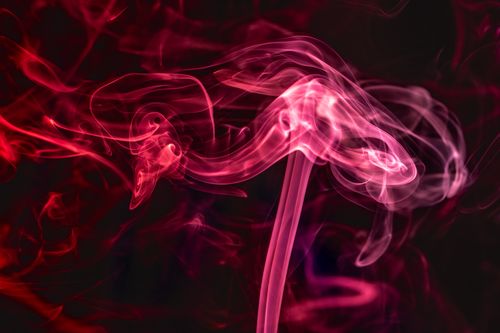 Free Captivating red smoke patterns swirling against a dark background, creating an abstract artistic effect. Stock Photo