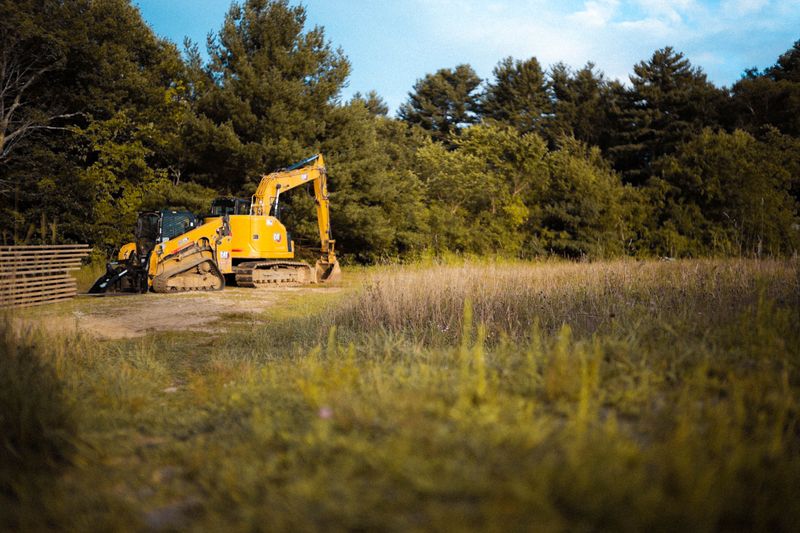 Land clearing equipment opening a wooded lot in Fulton, MS