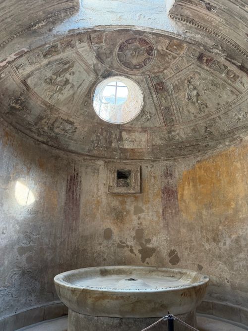 Free Intricate frescoes adorn the domed ceiling of a Roman ruin's bathhouse. Stock Photo