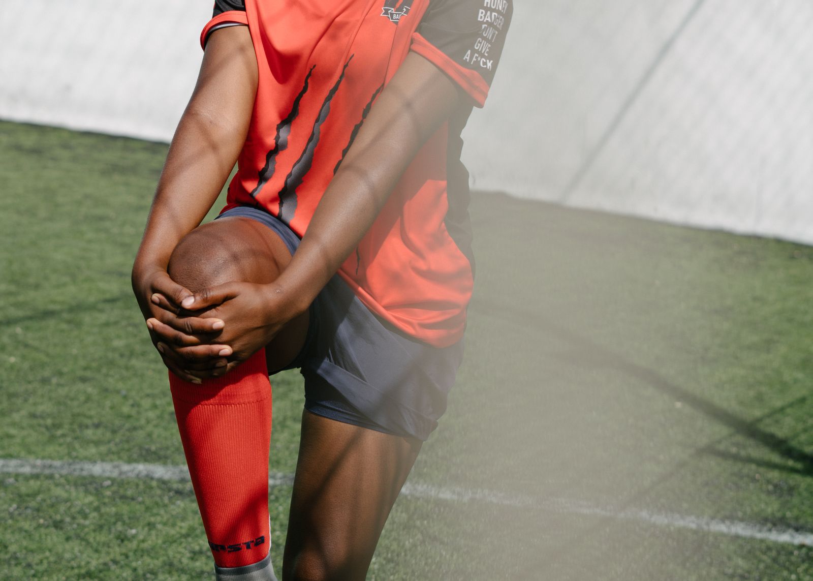 Person outdoors adjusting a knee sleeve before a walk