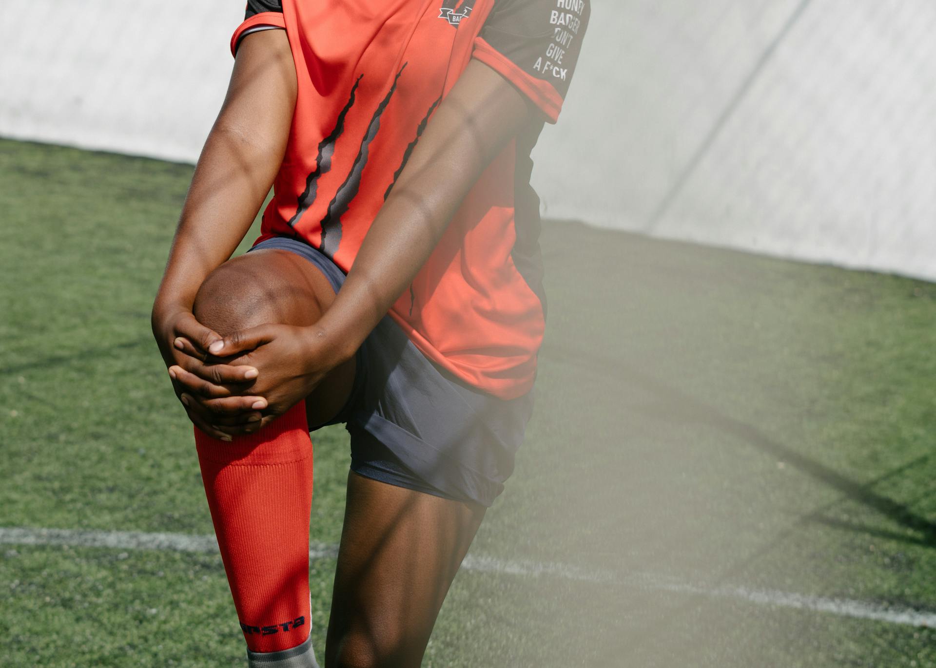 Anonymous soccer player warming up in training