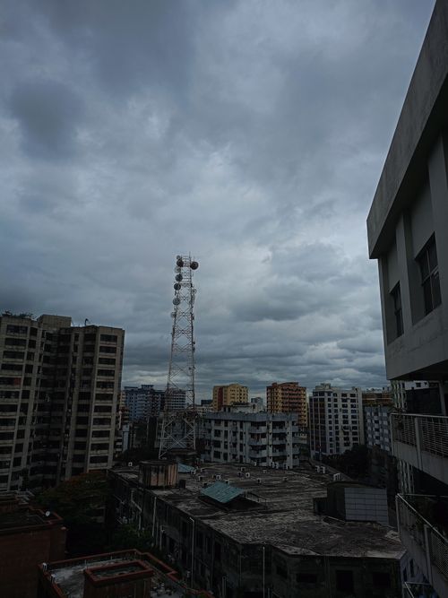 Free Dramatic overcast cityscape featuring urban buildings and a telecommunication tower in Dhaka, Bangladesh. Stock Photo