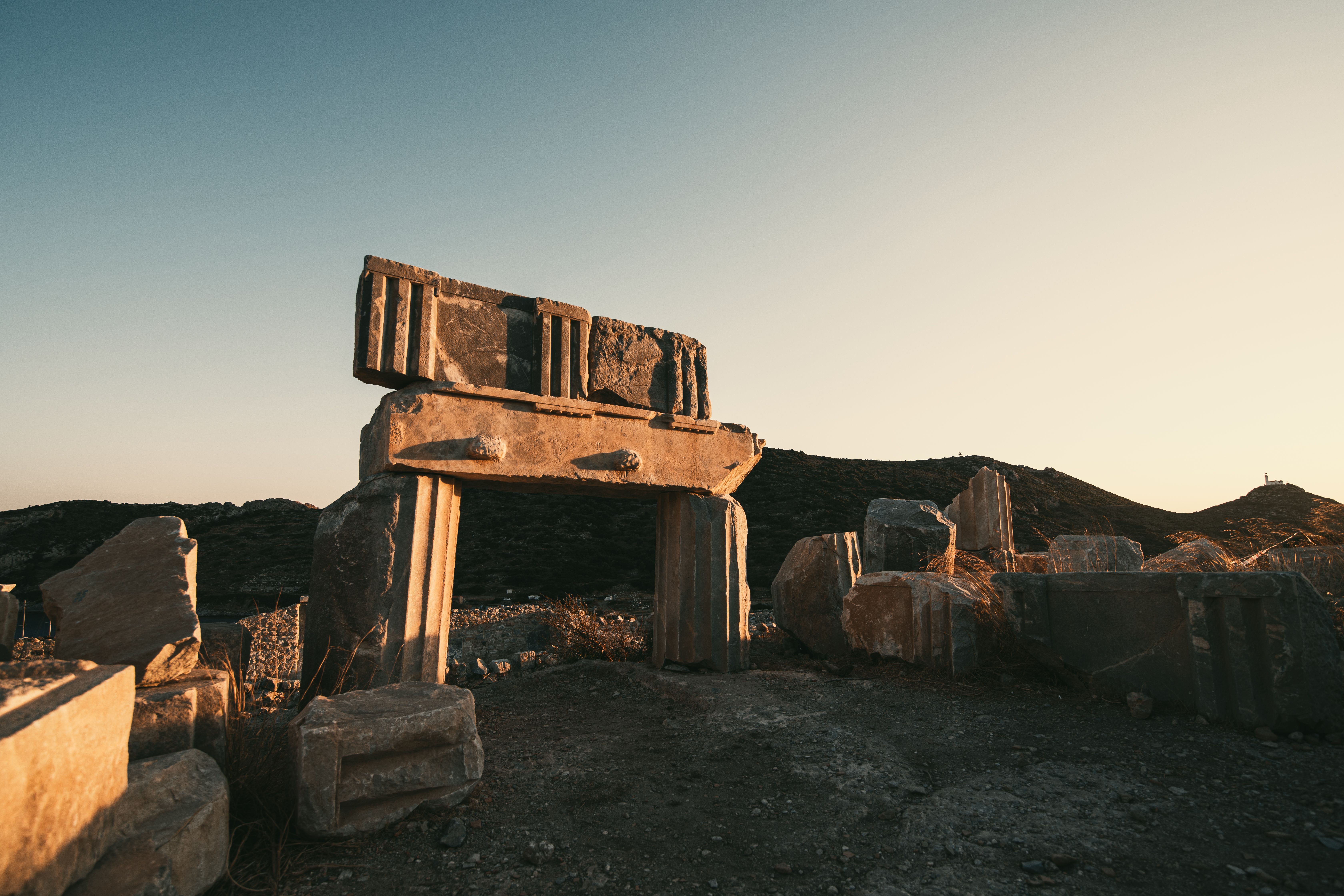Explore the majestic ancient stone ruins highlighted by the warm glow of sunrise.