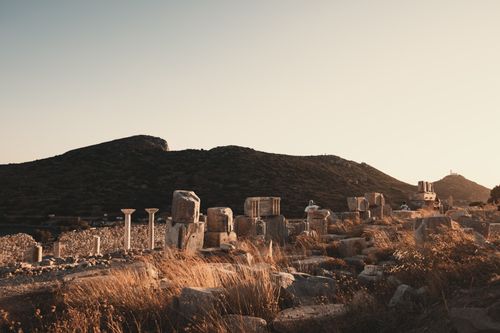Free Capture of ancient ruins in Greece with a warm, golden sunset in the background. Stock Photo