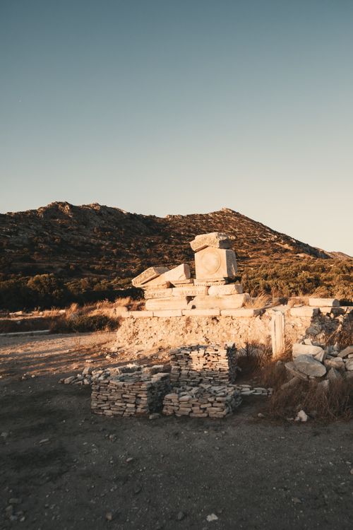Free Sunlit ruins nestled in a mountainous landscape during sunset, capturing historical serenity. Stock Photo