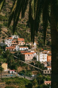 Charming hilltop village in Valle Gran Rey, La Gomera surrounded by lush palm trees and terraces.