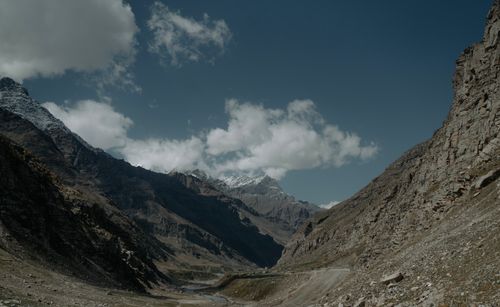 Free Stunning landscape of a mountain valley with snow-capped peaks beneath a clear blue sky. Stock Photo