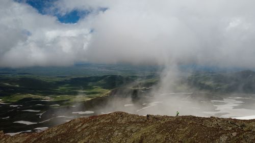 Free Captivating aerial view of foggy Armenian mountains with lush valleys and dramatic skies. Stock Photo