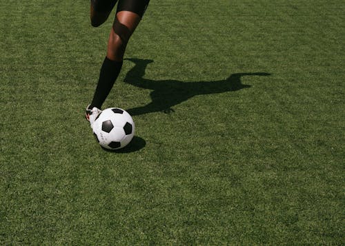 Free Anonymous soccer player on field during match Stock Photo