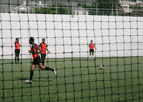 Girls Playing Soccer on Green Grass Field