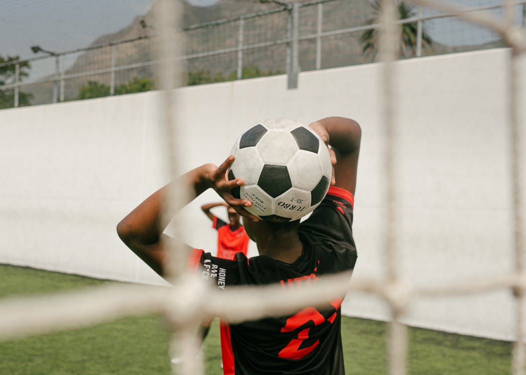 Free A Player Holding A Soccer Ball Stock Photo