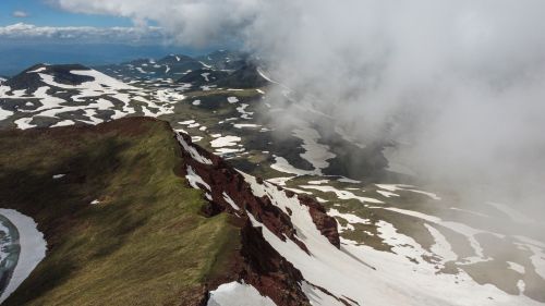 Free Breathtaking aerial view of snow-covered mountains and mist in Kotayk Province, Armenia. Stock Photo