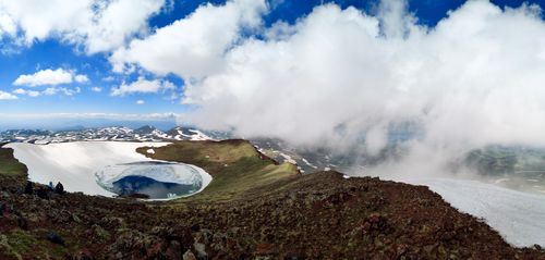 Free Explore the breathtaking crater lake surrounded by snow-capped mountains in Armenia's remote wilderness. Stock Photo