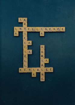 Scrabble tiles form words about AI ethics on a flat lay. Ideal for technology and education themes.