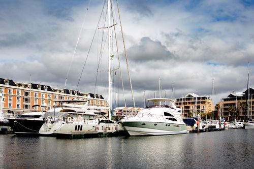 Free Scenic view of yachts docked at a marina in Cape Town, South Africa, with cloudy skies. Stock Photo