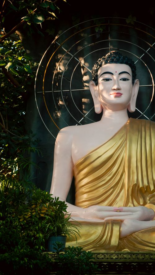 Free A peaceful Buddha statue surrounded by greenery in Ho Chi Minh City, Vietnam. Stock Photo
