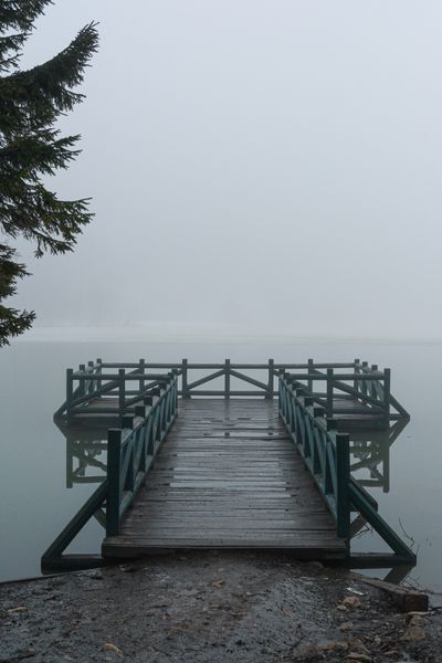 Wooden jetty reaching into a fog-covered lake, photo by hilal on Pexels