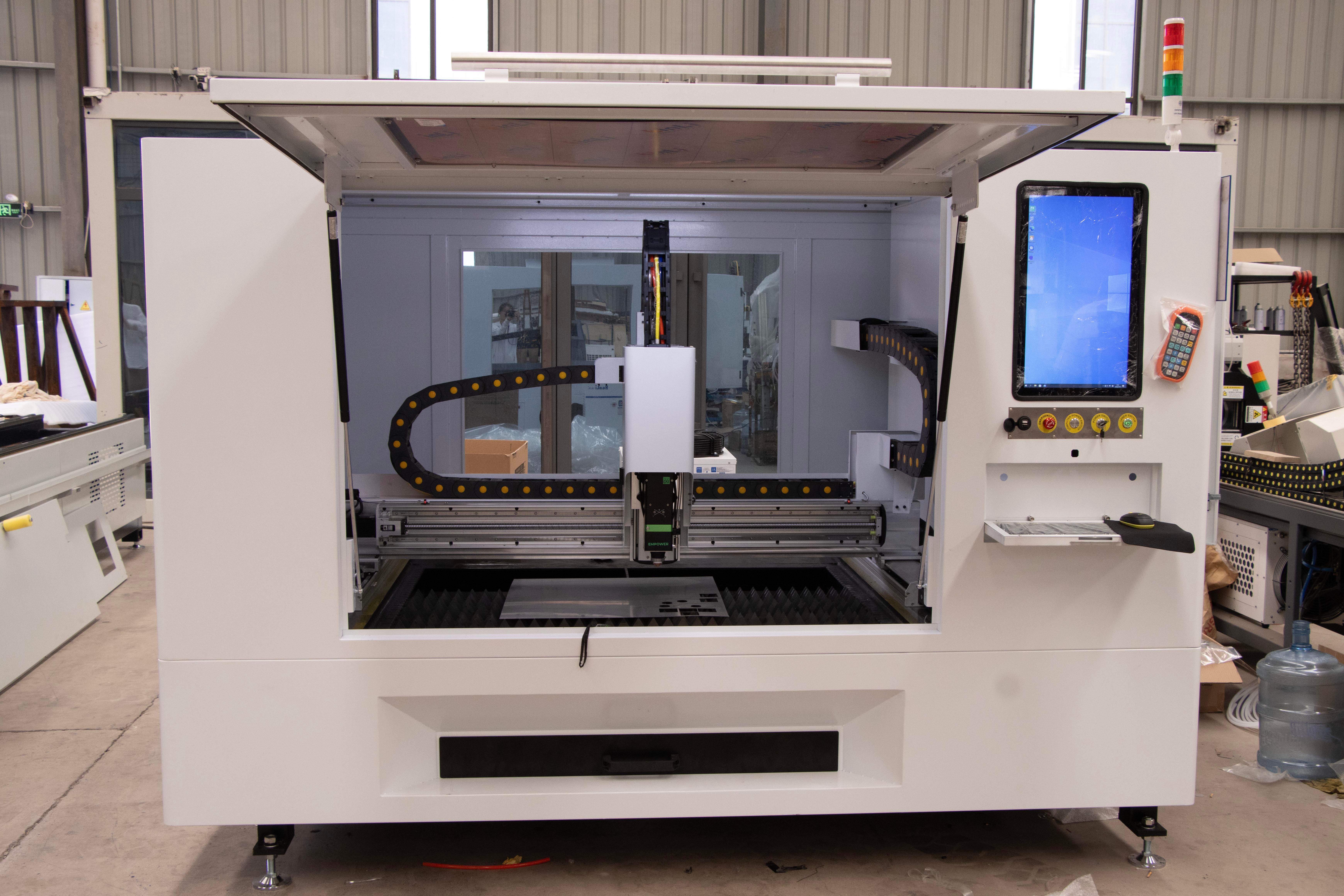 Front view of a high-tech CNC machine in an industrial factory environment.