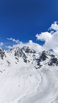 Majestic snow-capped mountains under a clear blue sky, showcasing nature's serene beauty.