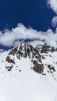 Explore stunning snow-draped mountain peaks against a vivid blue sky, perfect for winter and adventure themes.
