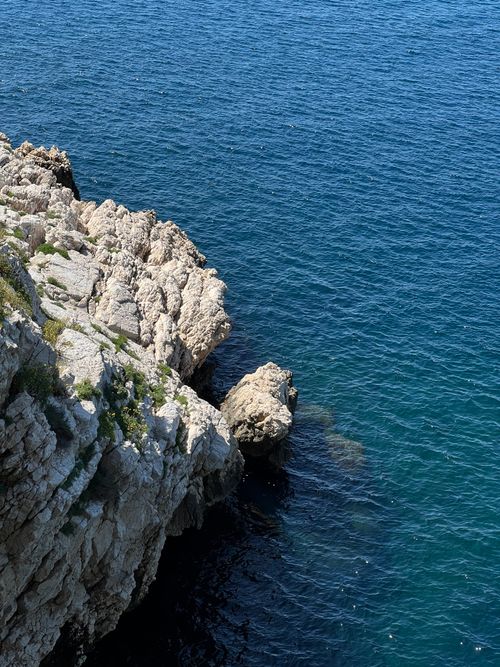 Free Aerial view of rocky coastline in Marseille with deep blue Mediterranean Sea. Stock Photo
