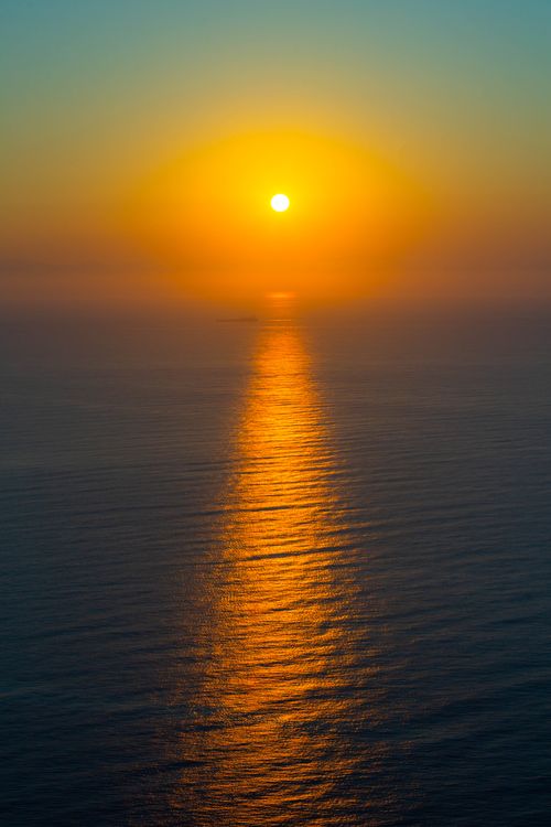 Free A stunning sunset casting vibrant reflections over the Ligurian Sea in Italy. Stock Photo